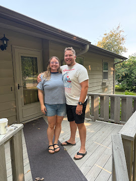 Two clients standing together on a home’s porch