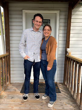 Two clients standing together on a covered porch
